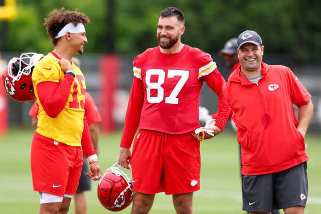 <p>Courtesy of The Chiefs</p> Porter Ellett, an assistant running backs coach for the Kansas City Chiefs, stands alongside Patrick Mahomes and Travis Kelce on the field.