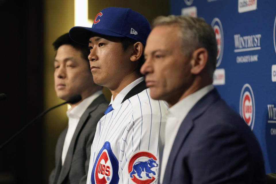 New Chicago Cubs pitcher Shōta Imanaga takes part in a news conference with Cubs president of baseball operations Jed Hoyer, right, and interpreter Shingo Murata, left, Friday, Jan. 12, 2024, in Chicago. The Japanese left-hander is expected to step right into the baseball team's rotation as it tries to return to the playoffs for the first time since 2020. (AP Photo/Nam Y. Huh)