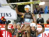 Ski Jumping - 65th four-hills ski jumping tournament final round - Bischofshofen, Austria - 06/01/2017 - Poland's Kamil Stoch celebrates among his compatriots after winning the 65th four-hills tournament. REUTERS/Dominic Ebenbichler