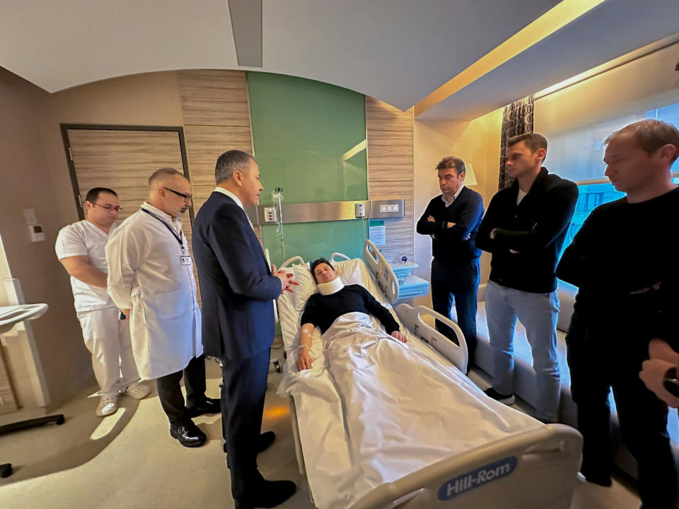 In this handout photo released by Turkish Interior Ministry, Turkish referee Halil Umut Meler, center, rests in a bed as he talks to Turkish Interior Minister Ali Yerlikaya, third left, at Acibadem hospital in Ankara, Tuesday, Dec. 12, 2023. The Turkish Football Federation has suspended all league games in the country after a club president punched the referee in the face at the end of a top-flight match. (Turkish Interior Ministry via AP)