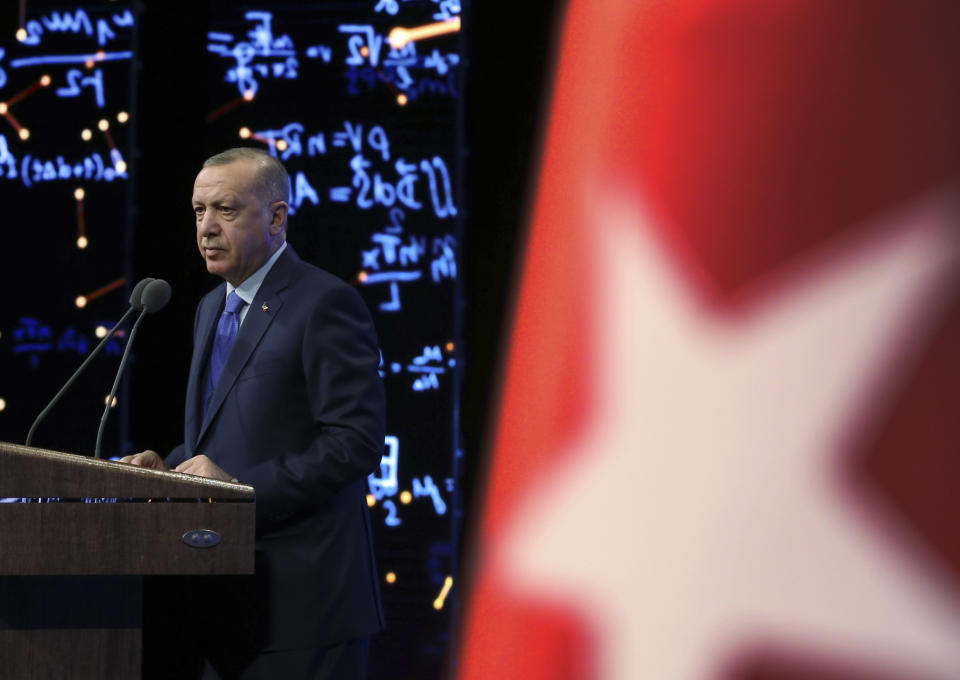 Turkey's President Recep Tayyip Erdogan delivers a speech at an event in Ankara, Turkey, Monday, Dec. 30, 2019. Turkey's government on Monday submitted a motion to parliament seeking approval to deploy troops to Libya, to help authorities in Tripoli defend the city from an offensive by rival forces, arguing that the conflict in the North African country could escalate into a civil war and threaten Turkey's interests.(Presidential Press Service via AP, Pool)