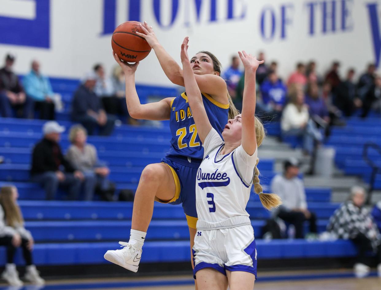 Jessica Schrader goes to the basket against Natalie Rath of Dundee during a 42-26 Dundee win Friday night.