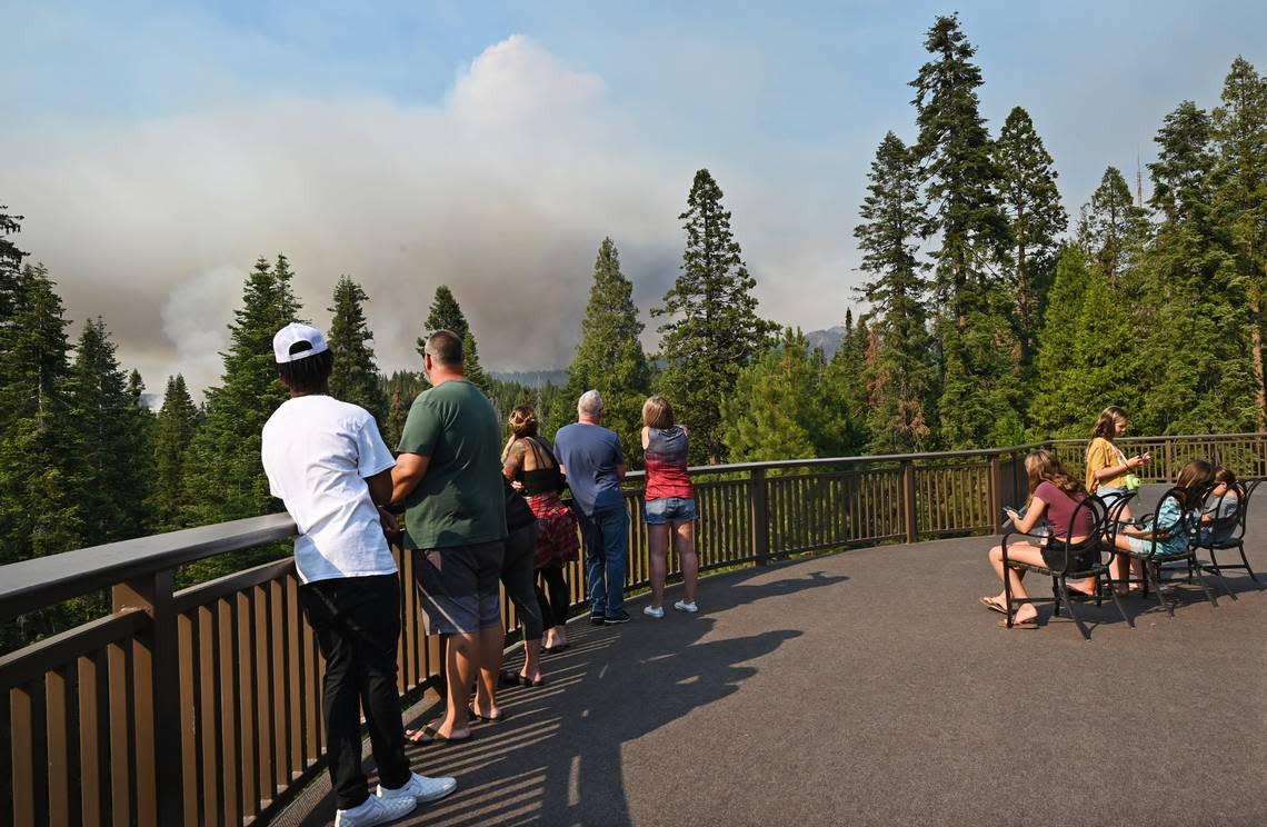 Guests at the Tenaya Lodge watch the Washburn Fire from a balcony as it burns near the south entrance of Yosemite National Park Saturday, July 9, 2022 in Fish Camp.