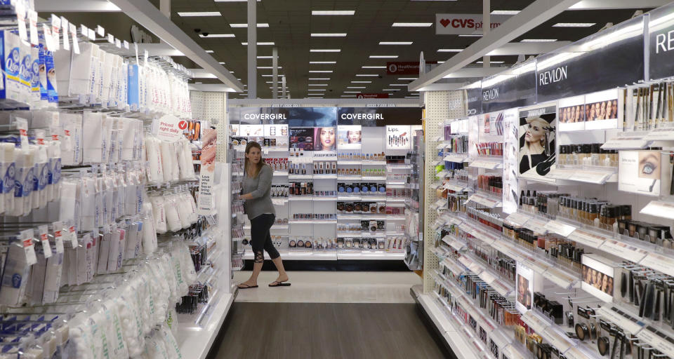 In this May 30, 2018, photo, a shopper looks through the updated cosmetic department at a Target store in San Antonio. Success of specialty chains like Sephora and Ulta has pushed discounters like Walmart and Target as well as drugstores like CVS to revamp their cosmetics areas with more open spaces, brighter lighting and more attractive fixtures. (AP Photo/Eric Gay)