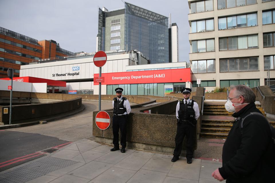 Police officers stand guard outside St Thomas' Hospital in central London on April 8, 2020 where Britain's prime minister began a third day in intensive care as he fights COVID-19. - Britain's Prime Minister Boris Johnson began a third day in intensive care on April 8 battling the coronavirus, which has struck at the heart of the British government, infected more than 55,000 people across the country and killed nearly 6,200. (Photo by ISABEL INFANTES / AFP) (Photo by ISABEL INFANTES/AFP via Getty Images)
