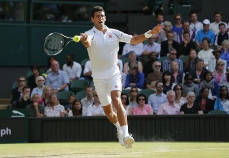 Novak Djokovic of Serbia hits a shot during his match against Marin Cilic of Croatia at the Wimbledon Tennis Championships in London, July 8, 2015. REUTERS/Suzanne Plunkett -