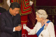 FILE - In this Tuesday Oct. 20, 2015 file photo, Chinese President Xi Jinping with Britain's Queen Elizabeth II during a state banquet at Buckingham Palace, London, on the first day of the state visit to Britain. Only five years ago, former British Prime Minister David Cameron was celebrating a “golden era” in U.K.-China relations, bonding with President Xi Jinping over a pint of beer at the pub and signing off trade deals worth billions. Those friendly scenes now seem like a distant memory, with hostile rhetoric ratcheting up this week over Beijing’s new national security law on Hong Kong. China has threatened “consequences” after Britain offered refuge to millions in the former colony. (Dominic Lipinski/Pool Photo via AP, File)
