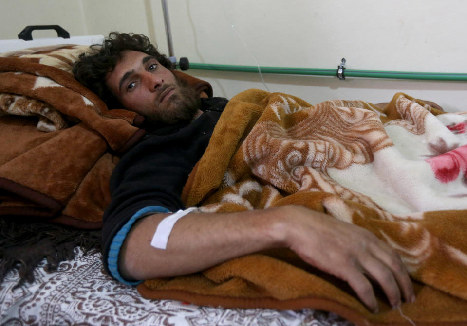 In this picture taken on Wednesday, March 5, 2014, Bassel, 27, a Syrian rebel who was injured during an ambush by the Syrian government forces near Yabroud, the last rebel stronghold in Syria's mountainous Qalamoun region, lies on his bed at a makeshift hospital in the Lebanese-Syrian border town of Arsal, eastern Lebanon. Trucks of armed fighters rumble from this Lebanese Sunni town through the mountains to the front in Syria, where rebels are in a furious fight to keep a vital stronghold. At the same time, Lebanese Shiite fighters from a town not far away are also streaming in to join the battle _ but on the opposing side, backing Syrian government forces. The battle has effectively erased the border between the two countries and underlines how dangerously Lebanon is being sucked into its neighbor’s civil war. (AP Photo/Hussein Malla)