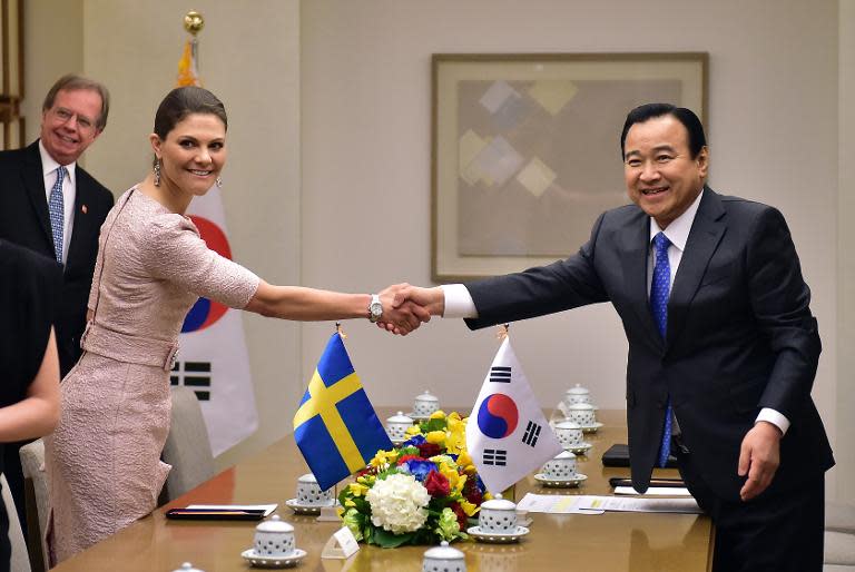 South Korean Prime Minister Lee Wan-Koo (R) shakes hands with Swedish Crown Princess Victoria during their meeting at Lee's official residence in Seoul on March 24, 2015