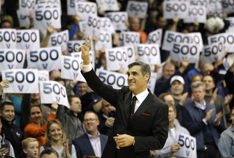 FILE - In this Feb. 22, 2017, file photo, fans cheer Villanova head coach Jay Wright in 500 wins before the start of an NCAA college basketball game against Butler in Villanova, Pa. Wright is starting his 19th season at Villanova, where he is already the winningest coach in program history. (AP Photo/Laurence Kesterson, File)