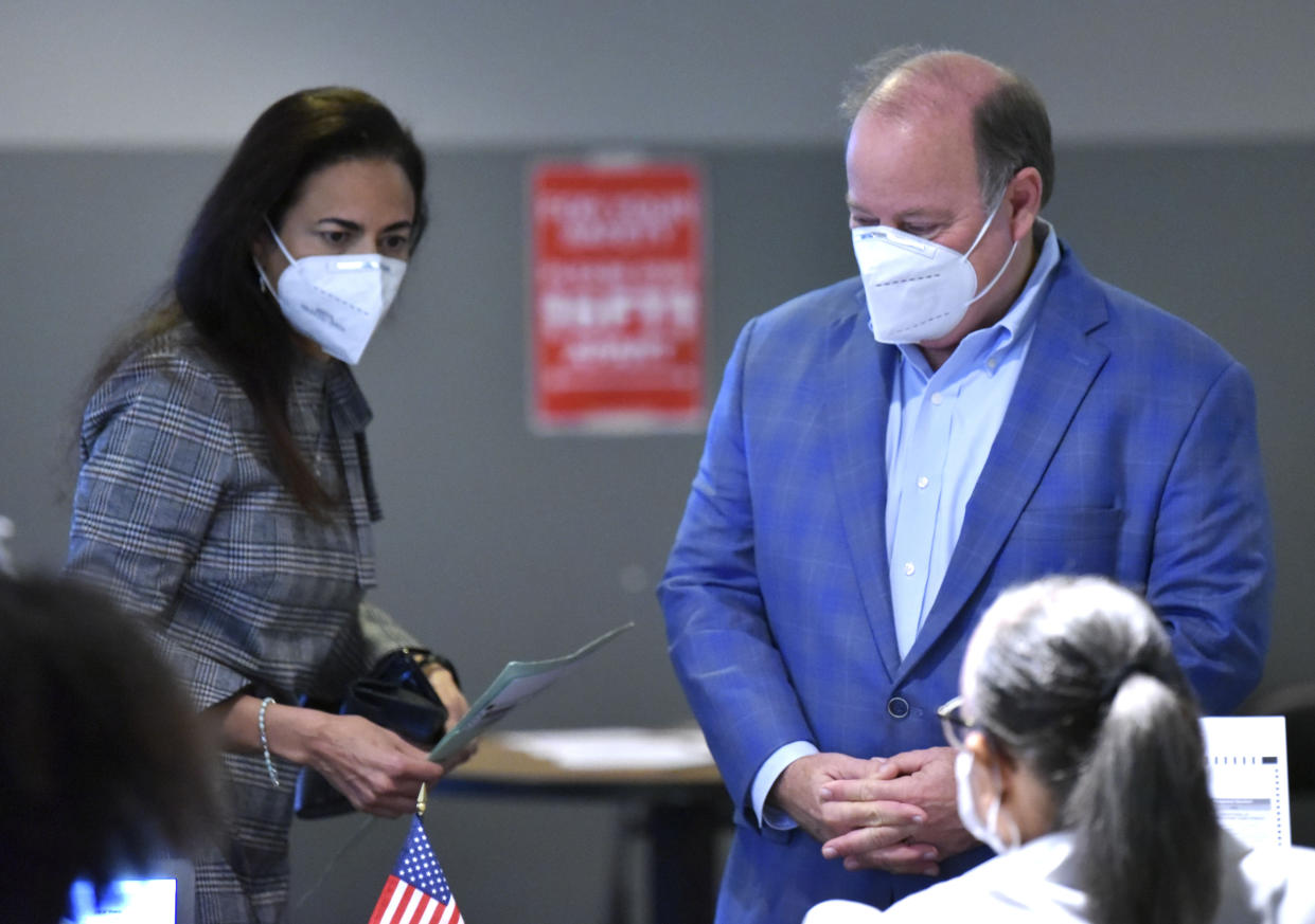 Detroit Mayor Mike Duggan, right, arrives with his wife, Dr. Sonia Hassan, to vote at the River House Apartments in Detroit, Tuesday morning, Nov. 2, 2021. The mayor is running for his third term. (Todd McInturf/Detroit News via AP)