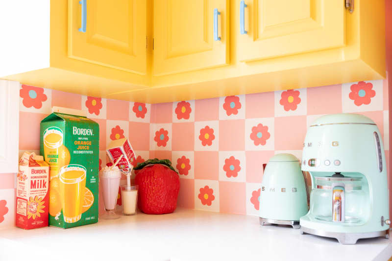 Pink floral motif wallpaper in kitchen.