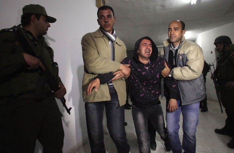 A Palestinian relative mourns the death of Arafat Jaradat, who died in an Israeli prison, before his funeral in the West Bank city of Hebron on February 24, 2013. Palestinian minister of prisoner affairs Issa Qaraqaa accused Israel of torturing Jaradat to death, citing the preliminary findings of an Israeli-Palestinian autopsy