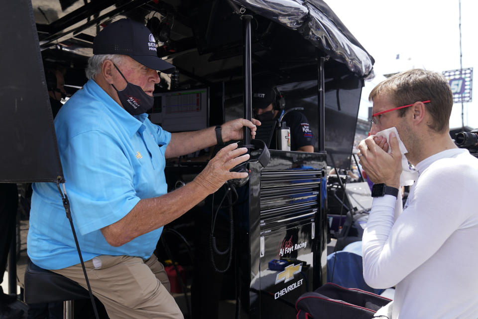 A.J. Foyt, left, talks with Sebastien Bourdais, of France, during practice for the Indianapolis 500 auto race at Indianapolis Motor Speedway, Friday, May 21, 2021, in Indianapolis. (AP Photo/Darron Cummings)