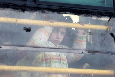 A Syrian girl rides a bus towards Turkey to the Bab Al-Salam border crossing, in Darat Izza, Aleppo countryside, Syria February 10, 2016. REUTERS/Ammar Abdullah