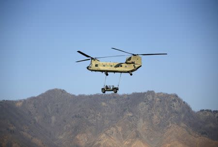 FILE PHOTO: A U.S Army CH-47 Chinook helicopter transports a military vehicle during a U.S.-South Korea joint live-fire military exercise at a training field in Pocheon, south of the demilitarized zone separating the two Koreas, March 25, 2015. REUTERS/Kim Hong-Ji/File Photo