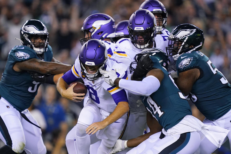 Minnesota Vikings quarterback Kirk Cousins (8) is sacked by Philadelphia Eagles defensive end Josh Sweat (94) during the first half of an NFL football game, Monday, Sept. 19, 2022, in Philadelphia. (AP Photo/Matt Rourke)