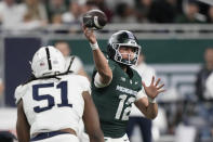 Michigan State quarterback Katin Houser (12) throws during the first half of an NCAA college football game against Penn State, Friday, Nov. 24, 2023, in Detroit. (AP Photo/Carlos Osorio)