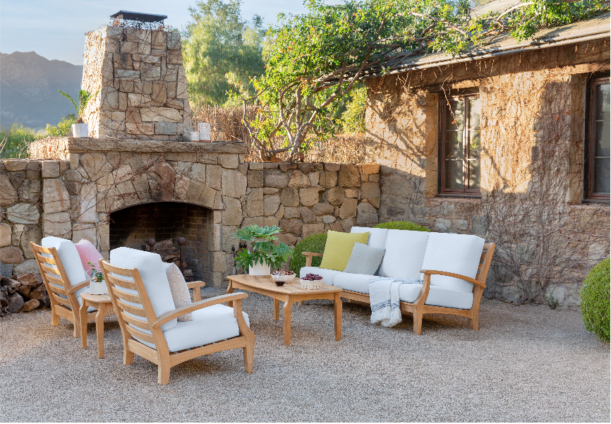 a group of chairs and a table outside a stone building