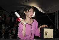 Jianying Chen, winner of the best short film award for 'The Water Murmurs' poses for photographers during the photo call following the awards ceremony at the 75th international film festival, Cannes, southern France, Saturday, May 28, 2022. (AP Photo/Petros Giannakouris)