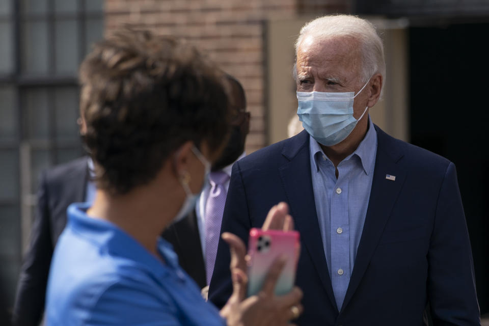 Democratic presidential candidate former Vice President Joe Biden is applauded as he arrives to pose for a photo with union leaders outside the AFL-CIO headquarters in Harrisburg, Pa., Monday, Sept. 7, 2020. (AP Photo/Carolyn Kaster)