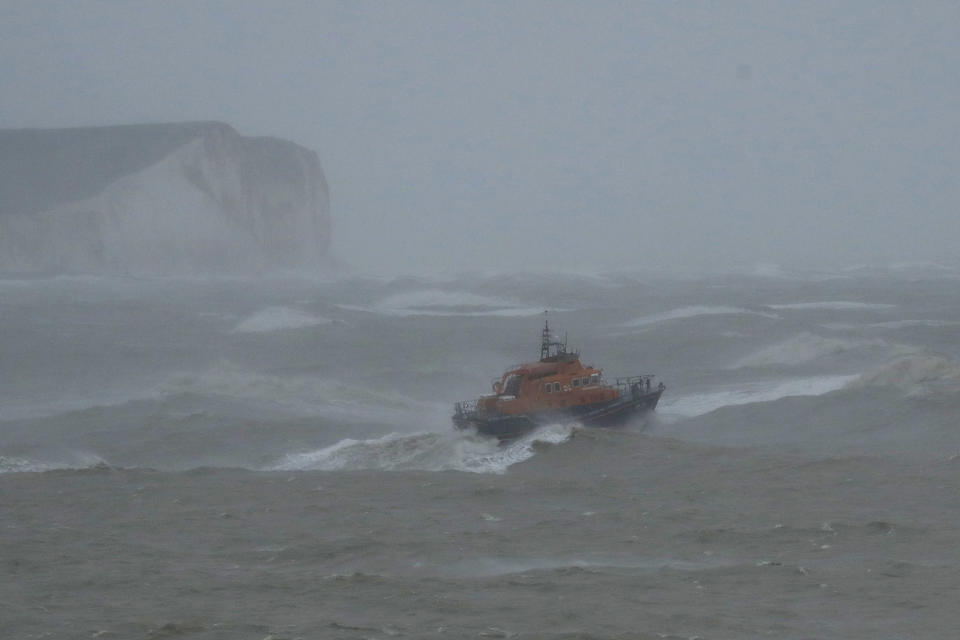 A lifeboat passes white cliffs, as Storm Ciara hits Newhaven, on the south coast of England, Sunday, Feb. 9, 2020. Trains, flights and ferries have been cancelled and weather warnings issued across the United Kingdom and in northern Europe as the storm with winds expected to reach hurricane levels batters the region. (AP Photo/Matt Dunham)