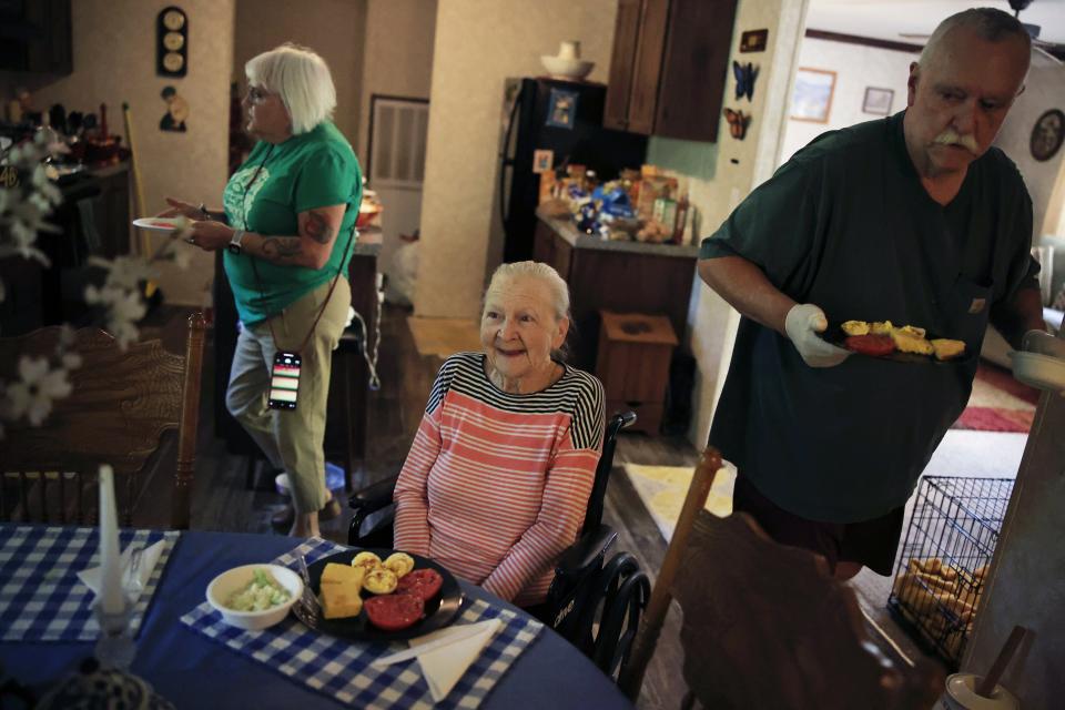 Margaret Woods (center) reacts to being served lunch at her Hastings home by Pie in the Sky Community Alliance volunteer Johnny Barnes (right) and program manager Phyllis Wood of Pie in the Sky Community Alliance. "They are a godsend," she said.