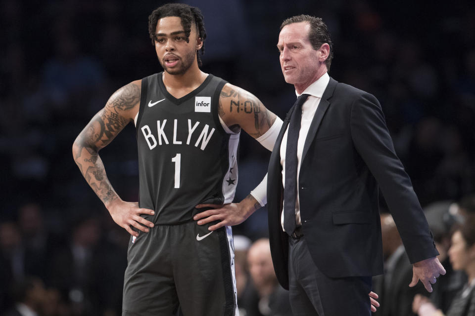 Brooklyn Nets head coach Kenny Atkinson talks to guard D'Angelo Russell (1) during the second half of Game 4 of a first-round NBA basketball playoff series, Saturday, April 20, 2019, in New York. The 76ers won 112-108. (AP Photo/Mary Altaffer)