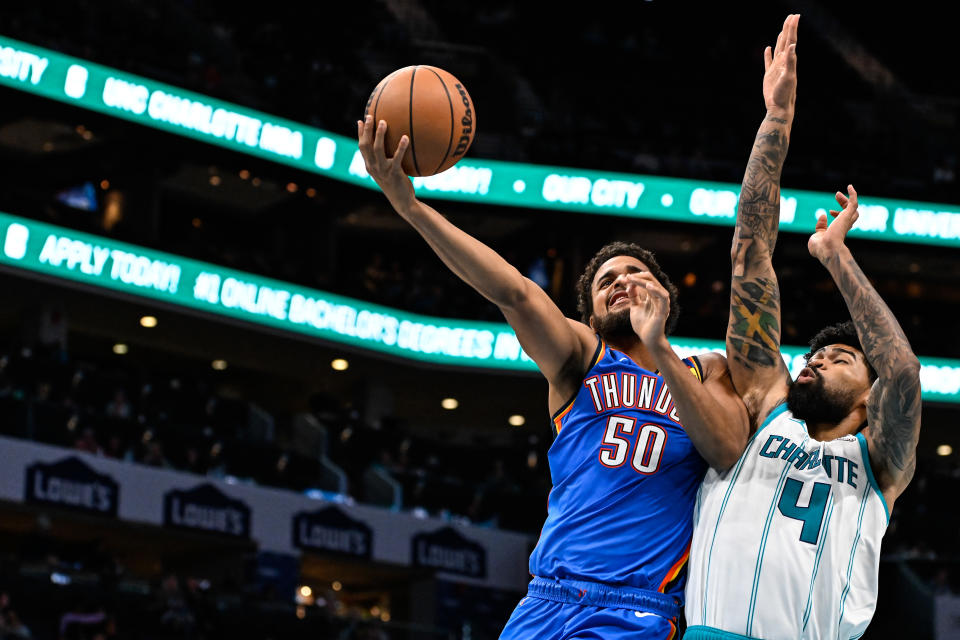 CHARLOTTE, NORTH CAROLINA – OCTOBER 15: Jeremiah Robinson-Earl #50 of the Oklahoma City Thunder drives to the basket against Nick Richards #4 of the Charlotte Hornets during the second half of their game at Spectrum Center on October 15, 2023 in Charlotte, North Carolina. (Photo by Matt Kelley/Getty Images)