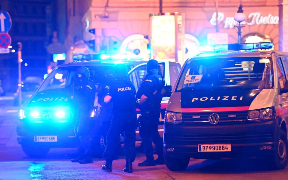 Police cars and policemen in central Vienna after the shooting - AFP