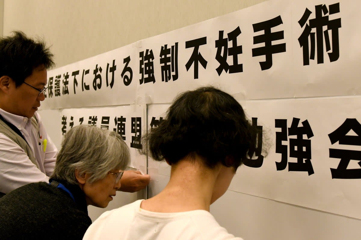 This photo from 29 March 2018 shows supporters of victims of Japan’s ‘eugenics’ programme preparing for a meeting with lawmakers in Tokyo (Toshifumi Kitamura/AFP via Getty)