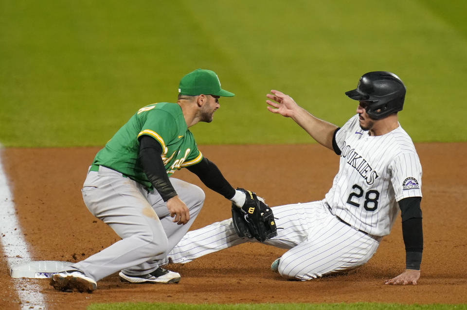 Oakland Athletics third baseman Tommy La Stella tags out Colorado Rockies' Nolan Arenado during the eighth inning of a baseball game, Tuesday, Sept. 15, 2020, in Denver. (AP Photo/Jack Dempsey)