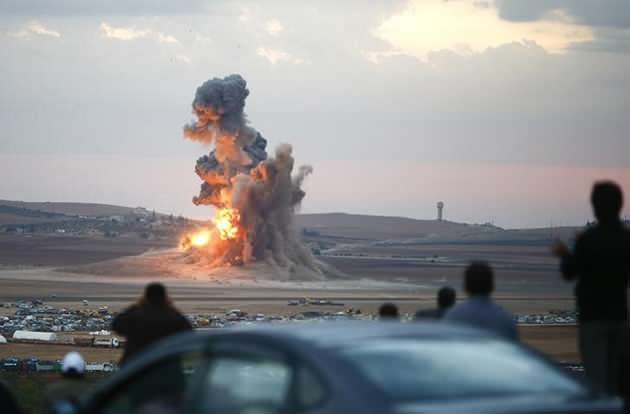 Smoke and flames rise over a hill near the Syrian town of Kobani after an airstrike, as seen from the Mursitpinar crossing. Photo: Reuters