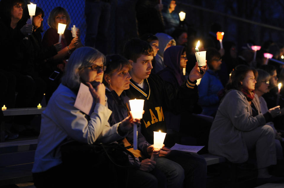 People raise candles as they listen to Maren Sanchez sing during a vigil for her at Jonathan Law High School, Monday, April 28, 2014, in Milford, Conn. Sanchez was fatally stabbed inside the school on Friday hours before her junior prom. (AP Photo/Jessica Hill)