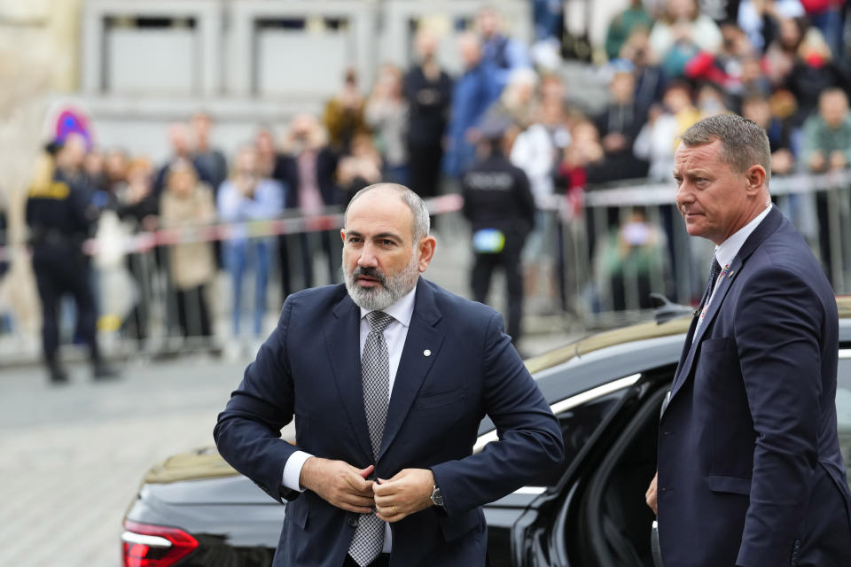 Armenia's Prime Minister Nikol Pasjinian, left, arrives for a meeting of the European Political Community at Prague Castle in Prague, Czech Republic, Thursday, Oct 6, 2022. Leaders from around 44 countries are gathering Thursday to launch a "European Political Community" aimed at boosting security and economic prosperity across the continent, with Russia the one major European power not invited. (AP Photo/Petr David Josek)