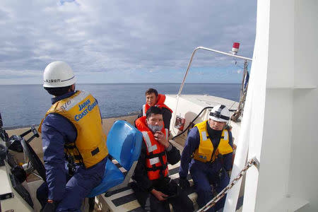 Vietnamese crew members of a South Korean trawler are carried by a boat launched from Japan Coast Guard patrol vessel Bukou, after a South Korean trawler and a Japanese fishing boat collided in the Sea of Japan, in this handout photo taken November 15, 2018 and provided by Japan Coast Guard. 9th Regional Coast Guard Headquarters - Japan Coast Guard/Handout via REUTERS