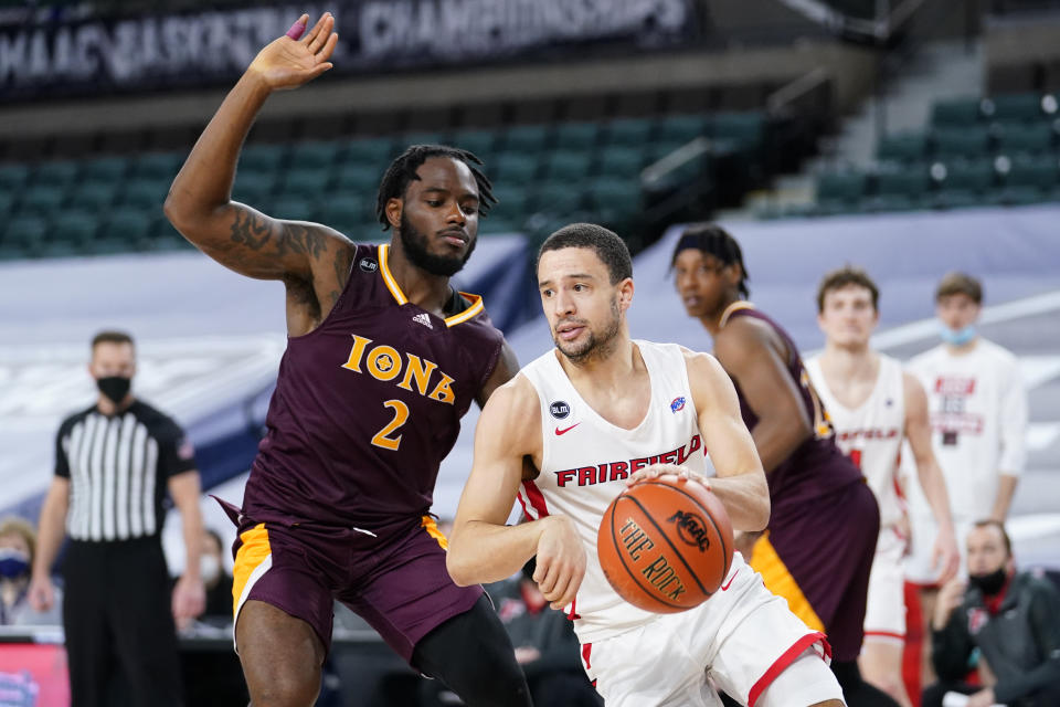 Fairfield's Caleb Green, right, dribbles past Iona's Asante Gist in the second half of an NCAA college basketball game during the finals of the Metro Atlantic Athletic Conference tournament, Saturday, March 13, 2021, in Atlantic City, N.J. (AP Photo/Matt Slocum)