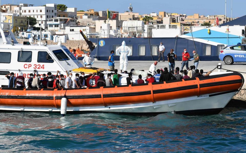 Migrants arrive in Lampedusa after being picked up by the Italian coast guard - AFP