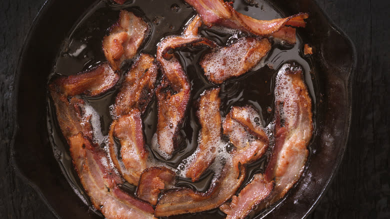 frying bacon strips in pan