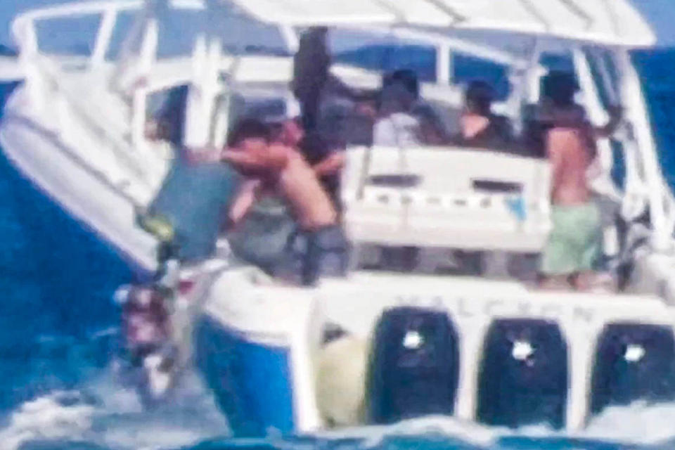 A video still of boaters dumping trash off a boat into the ocean (Wavy Boats / YouTube)