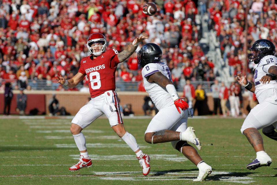 OU quarterback Dillon Gabriel (8) throws a pass over TCU linebacker Shad Banks Jr. (0) during the Sooners' 69-45 win Friday at Gaylord Family-Oklahoma Memorial Stadium in Norman.