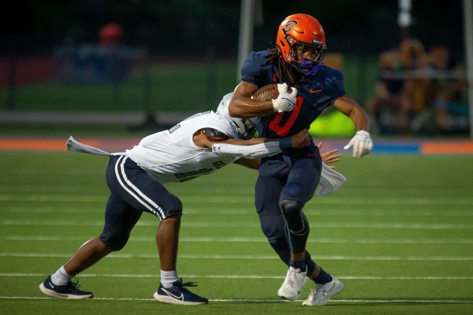 Jacob Cosby-Mosley (11) carries the oblong leather athletic ball during FHSAA boys football action as host The Benjamin School Buccaneers take on the Gulliver Prep Raiders in Palm Beach Gardens, Fla., on September 14, 2023.