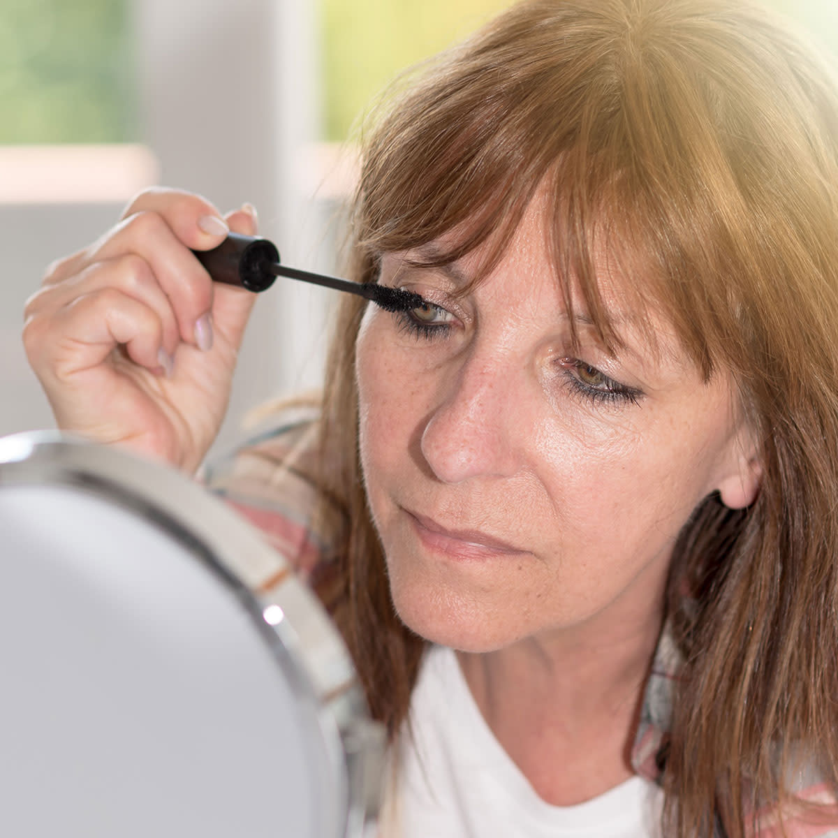 middle-aged-woman-applying-mascara