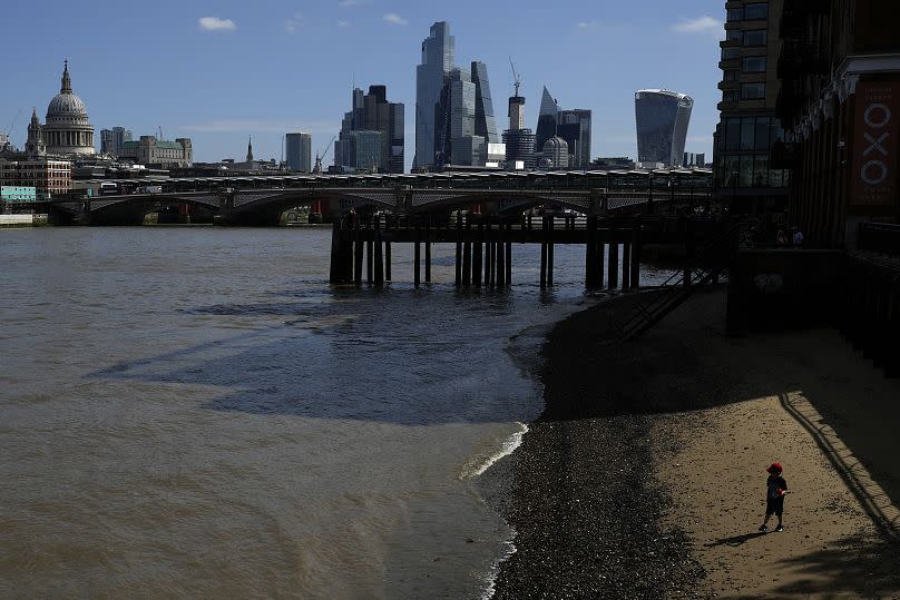 A child runs on the beach alongside the River Thames in London, August 2023.