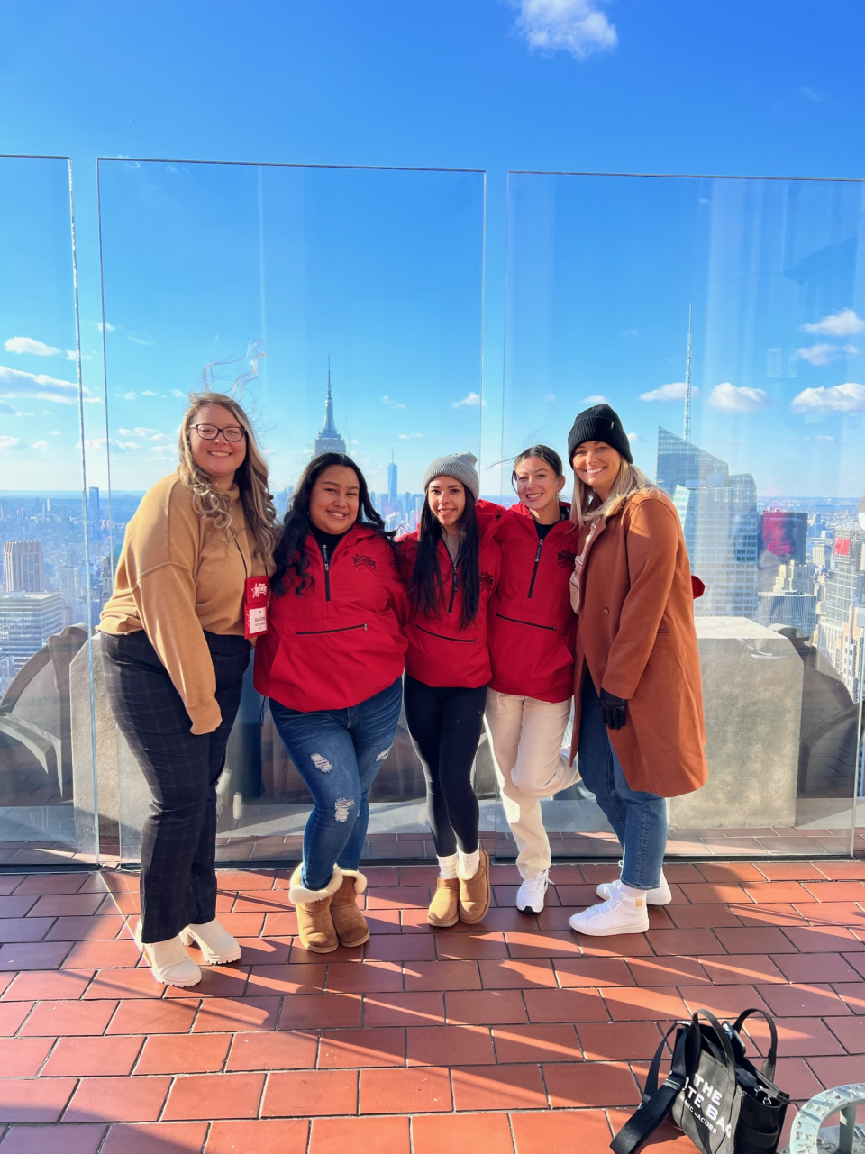 JV Coach Ashlyn Wilkerson, students Vanessa Arredondo-Alamilla, Olivia Decruz and Abby Perez-Ramirez, and Coach Lauren Albert at the observation deck on the top of Rockefeller Center in New York City. The students, part of Flagler-Palm Coast High School's Starlets dance troupe, performed in the 2022 Macy's Thanksgiving Day Parade.