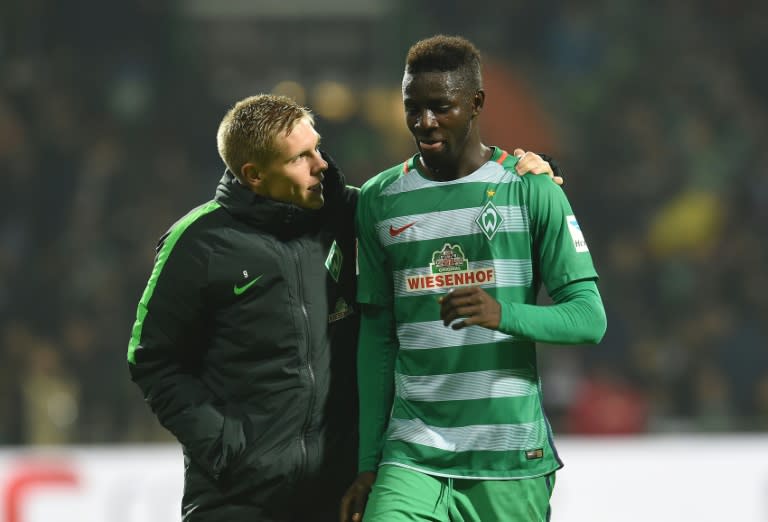 Ousman Manneh (right) speaks with Werder Bremen's Aron Johansson during the match against Bayer Leverkusen in Bremen on October 15, 2016