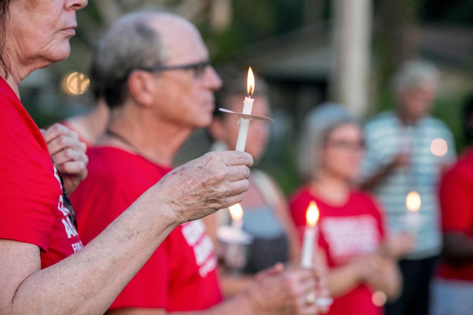 Mourners participate in the candlelight vigil during the "Ajike “AJ” Owens: Mourning a Mother and Others Taken by Gun Violence" vigil at GNV Bridge Community Center in Gainesville, FL on Wednesday, August 2, 2023. Community groups gathered together for a vigil and call to action for the Ocala mother. Owens was fatally shot by her neighbor Susan Lorincz in June when she went to her door. Lorincz was arrested on June 6 and charged in the shooting. The event is hosted by GNV Bridge, Greater Duval Neighborhood Association, Moms Demand Action for Gun Sense, the Alachua County branch of the NAACP, M.A.M.A.’s Club, Beyond Grieving LLC, and the Against All Odds Movement.