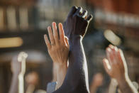 FILE - This photo from Sunday May 31, 2020, shows demonstrators raising their hands during a rally in Brooklyn, N.Y., for George Floyd, a black man who died in Minneapolis after being restrained by police officers. The chaos unleashed in 2020, amid the coronavirus pandemic, has created space for different voices to speak, for different conversations to be had and for different questions to be asked. (AP Photo/Kevin Hagen, File)