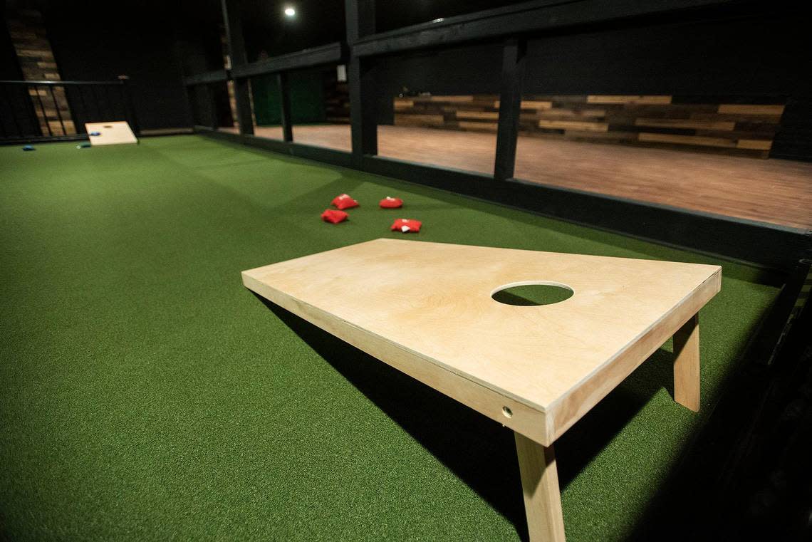 An area to play cornhole inside Joystiq, a bar, arcade and restaurant venue located at 325 W. Main Street in Merced, Calif., on Wednesday, Oct. 5, 2022.