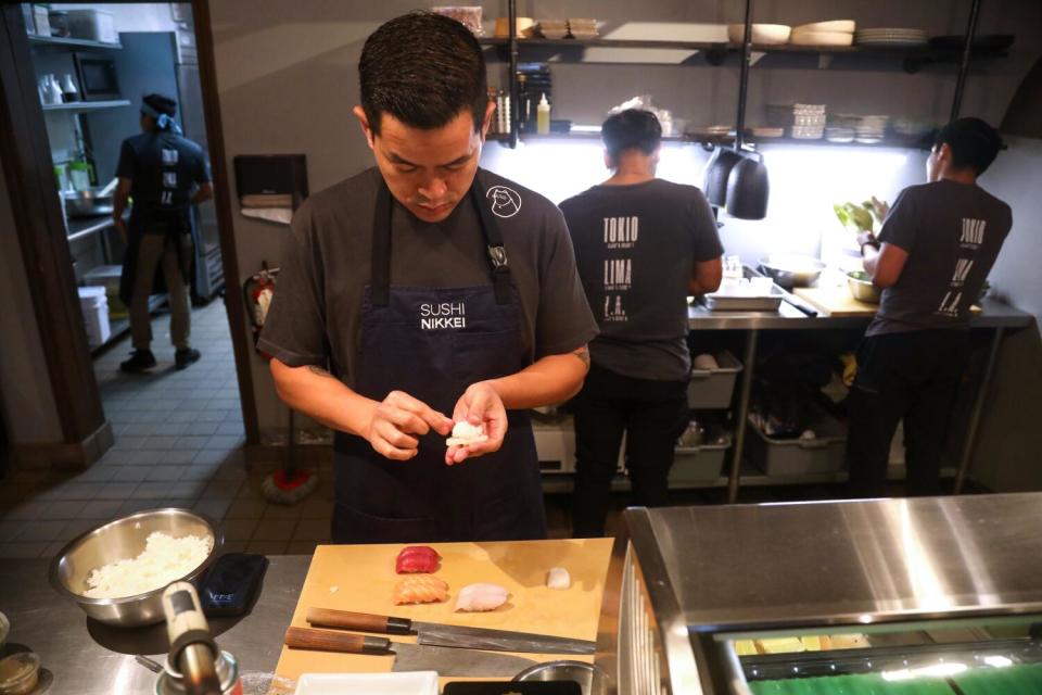 Chef Eduardo Chang prepares a plate of sushi